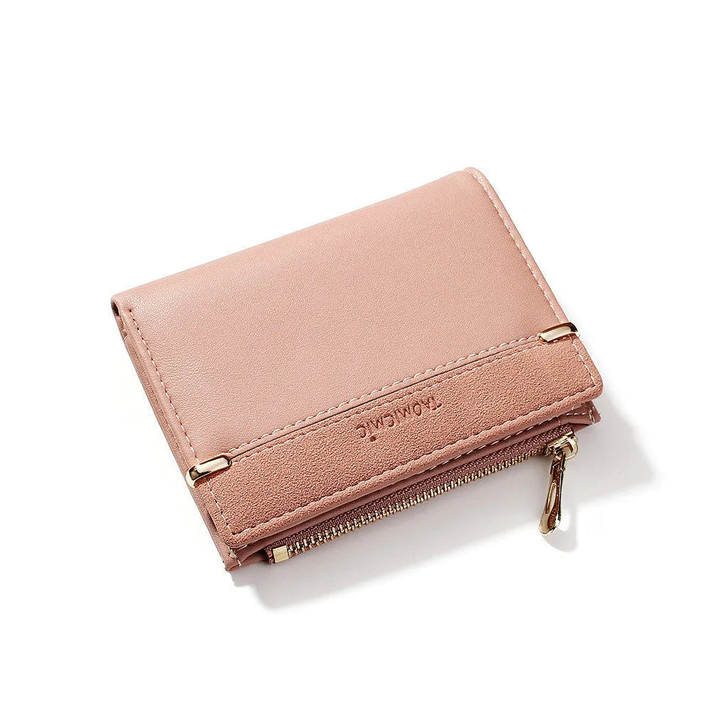 Black ladies short zipper wallet open to show multiple card slots, bill compartment, and change slot.