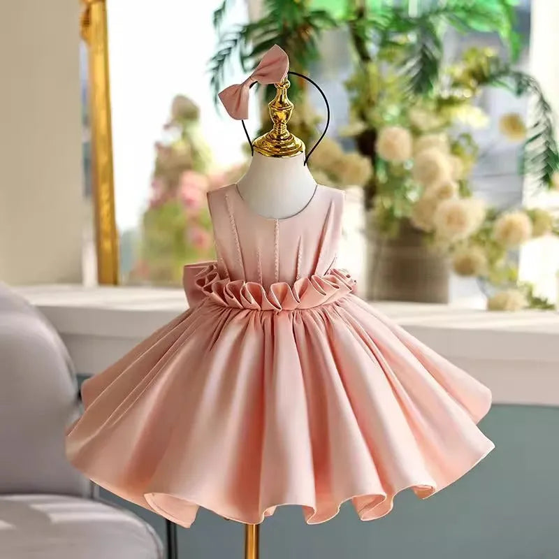 Children's princess dress in flesh pink polyester for piano performance with full skirt and fitted bodice