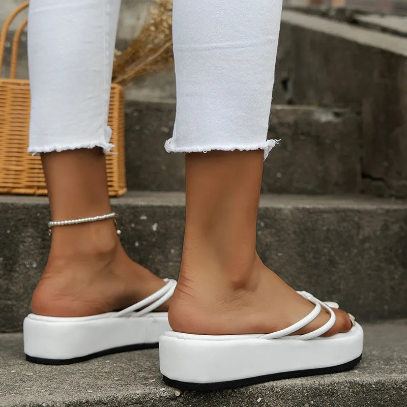 Thick bottom herringbone pattern flip-flops in multiple colours on a light background.