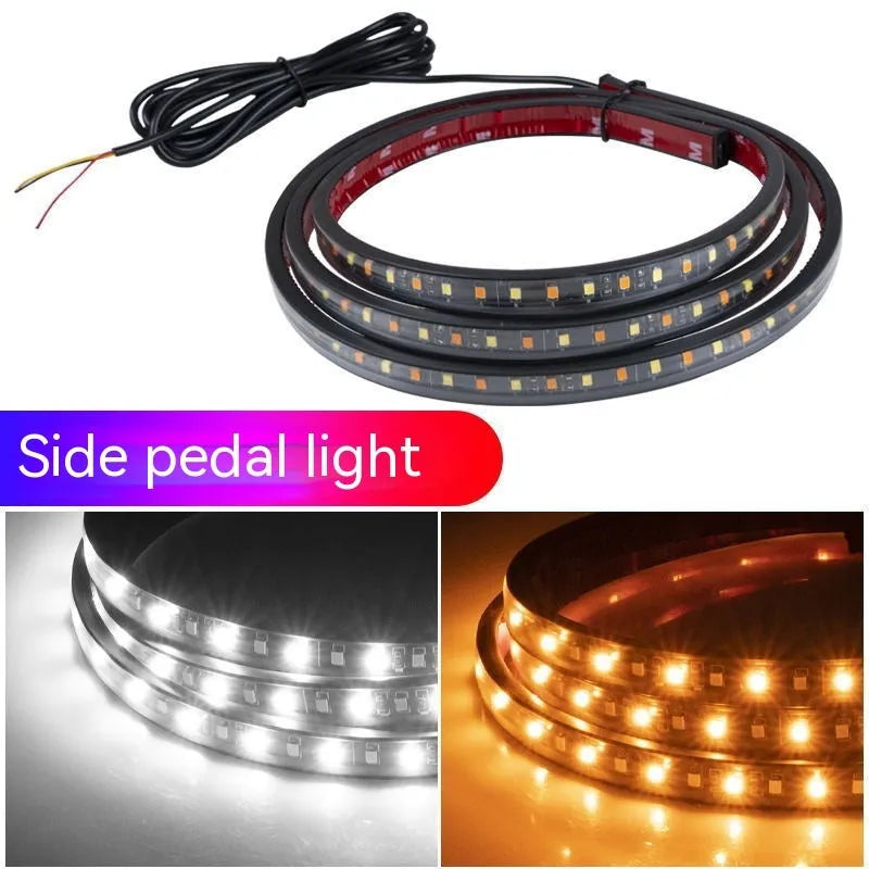 Pair of yellow pedal streamer side light lamps in flexible PVC casing on a dark background