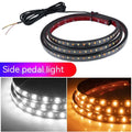 Pair of yellow pedal streamer side light lamps in flexible PVC casing on a dark background