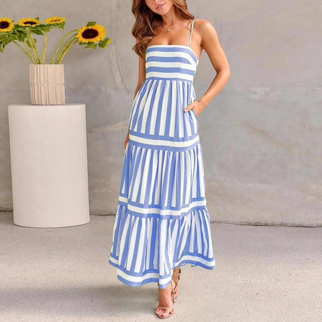 Woman wearing a striped, backless long summer dress with square neckline, suspender straps, and side pockets.