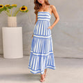 Woman wearing a striped, backless long summer dress with square neckline, suspender straps, and side pockets.