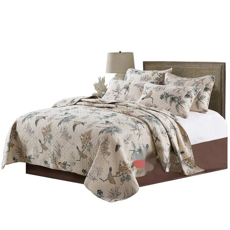 Quilted pure cotton bed cover and pillowcase set laid on a double bed, showing detailed printed pattern.