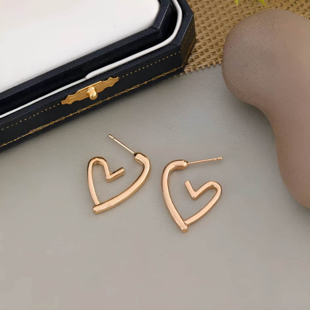 Simple cold style love earrings for women in golden colour metal alloy finish