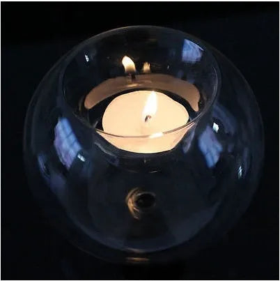 Handmade clear round hollow glass candle holder in European style on a table.