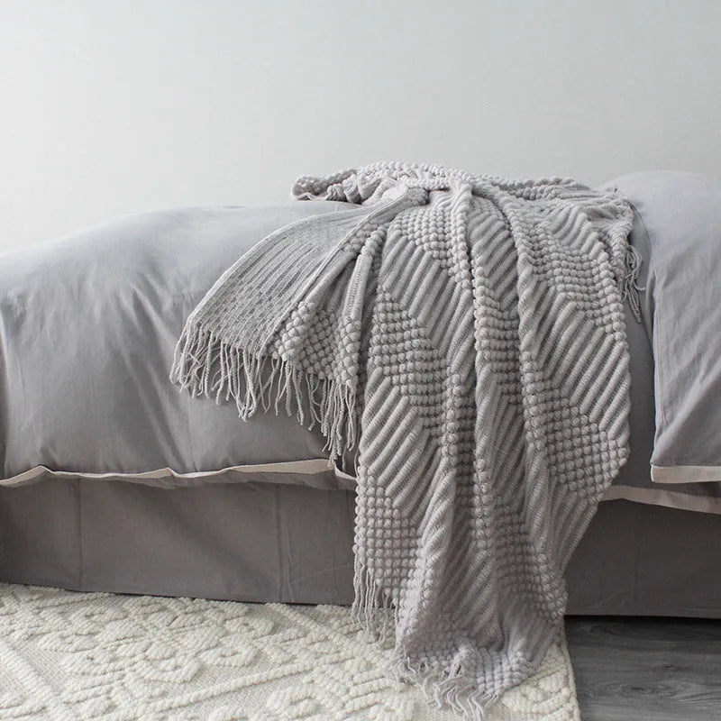 Small light grey polyester nap blanket laid flat showing its 127x170cm size.