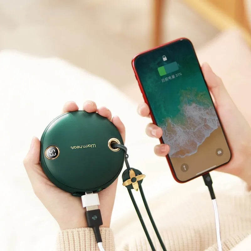 Green hand warmer power bank with digital display showing battery level, next to a USB-C cable.