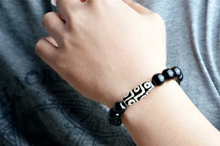 Natural black agate bracelet with nine eyes beads on neutral background, three size options 10mm 12mm 14mm