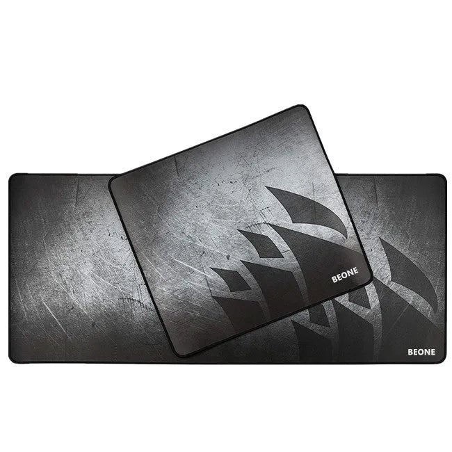 Black thickened non-slip mouse pad with rubber base and cloth surface on a desk