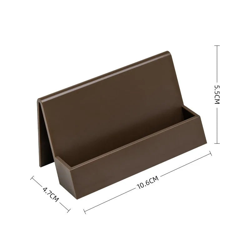 Creative PS geometric business card stand in brown, holding 20 cards upright on a desk.