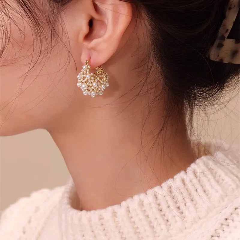 Gold tone women's flower basket earrings with small rice-shaped beads and pearl inlay detail