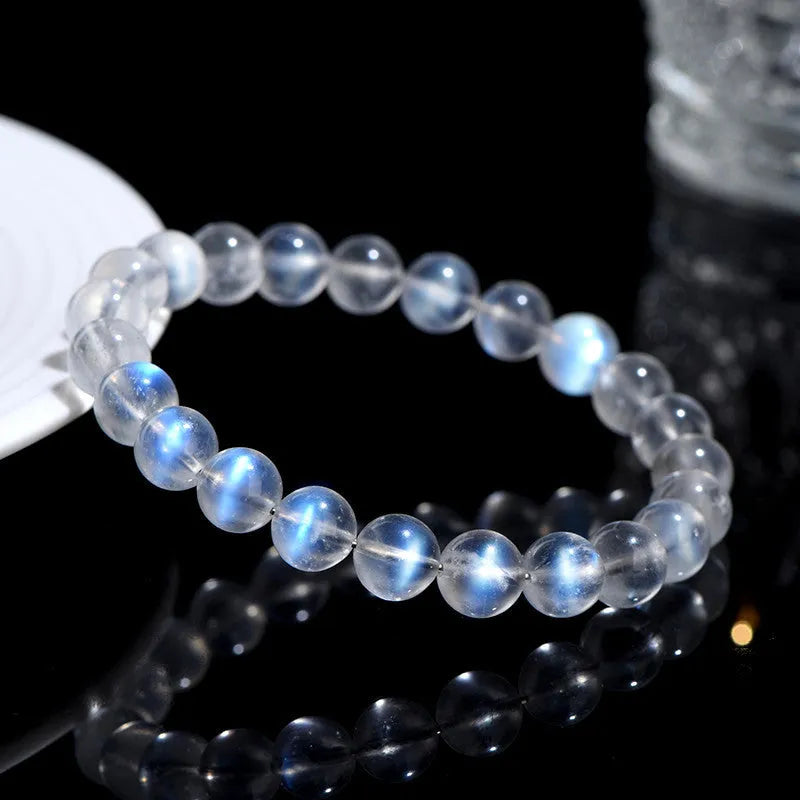 Natural cream coloured Blue Moonlight crystal bracelet on a wrist, showing minimalist unisex design.