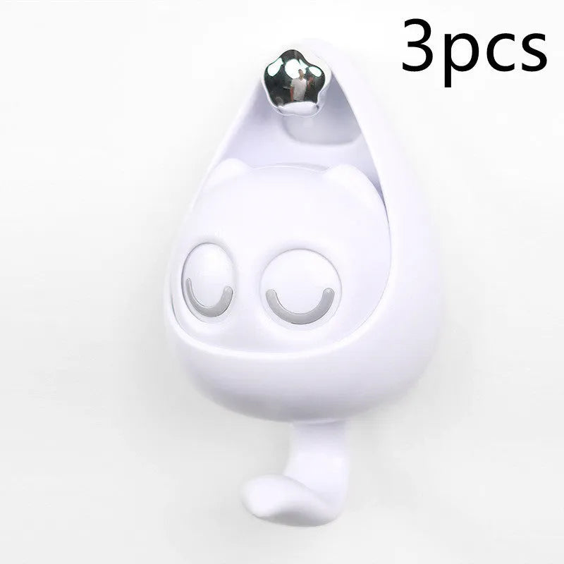 Cream white cat-shaped adhesive wall hook with winking eyes, 2.5kg capacity, 105x61x45mm