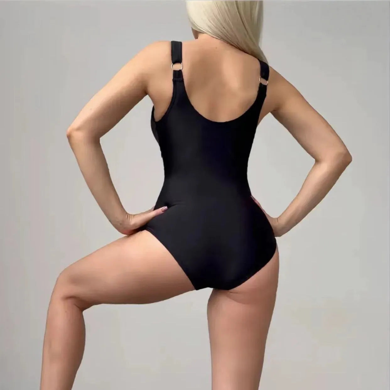 Women's black nylon one-piece swimsuit with lace-up front, tight fit, available in sizes S to XXL