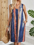 A woman's sleeveless V-neck dress with a colour block design and mid-length skirt.