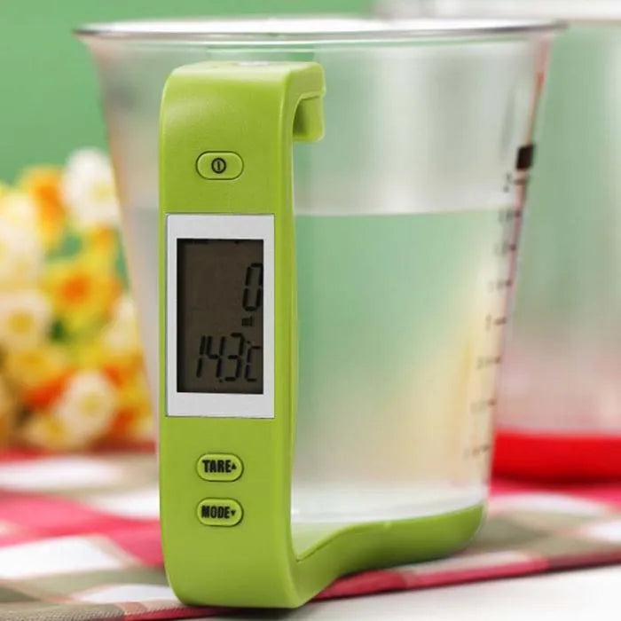 Green electronic kitchen scale measuring cup with LCD display in handle