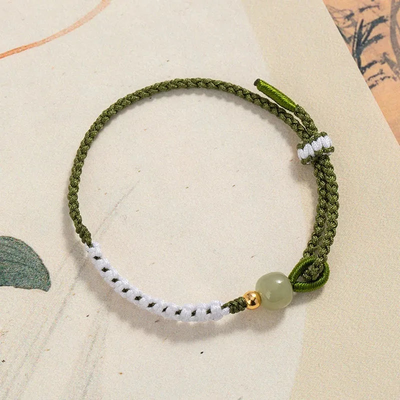 Hetian jade and sterling silver bracelet on a colourful electroplated cord strap.