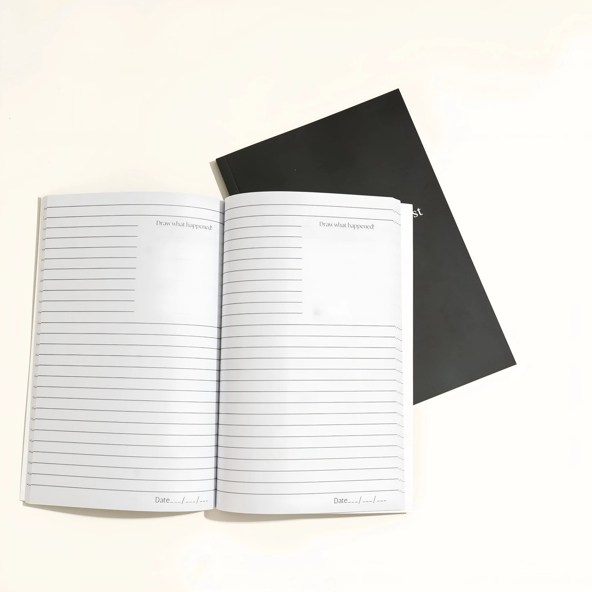 Black cover Dream Journal notebook with business simplicity styling, open on a page.
