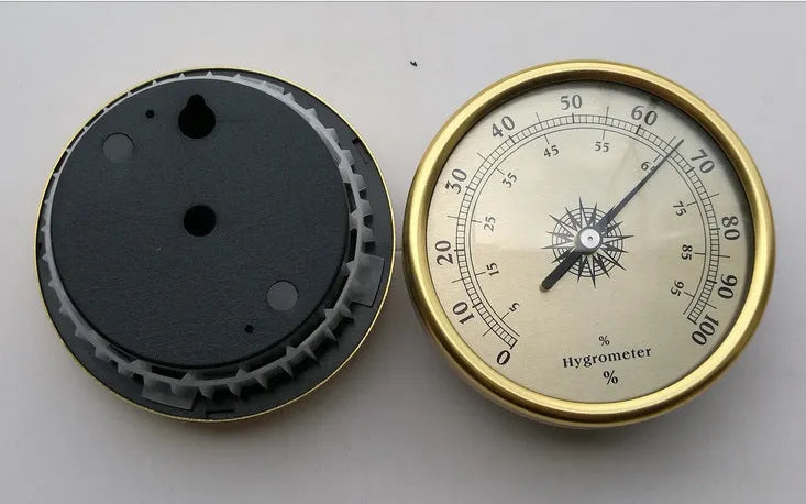 Silver aluminium analog thermometer and hygrometer on a white background.
