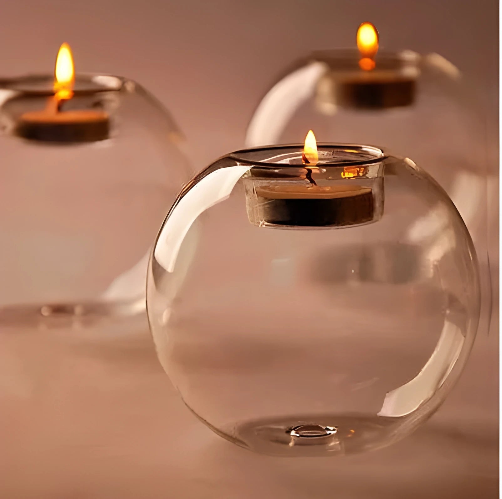 Handmade clear round hollow glass candle holder in European style on a table.