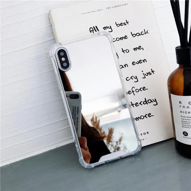 TPU mirror phone case for iPhone on a table, showing anti-fingerprint finish.