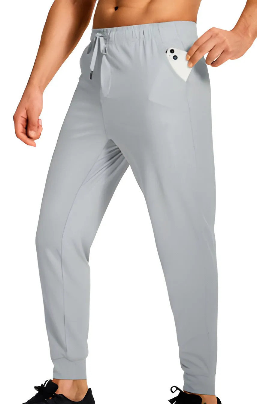 Men's loose fit solid colour casual trousers in polyester fabric on a hanger