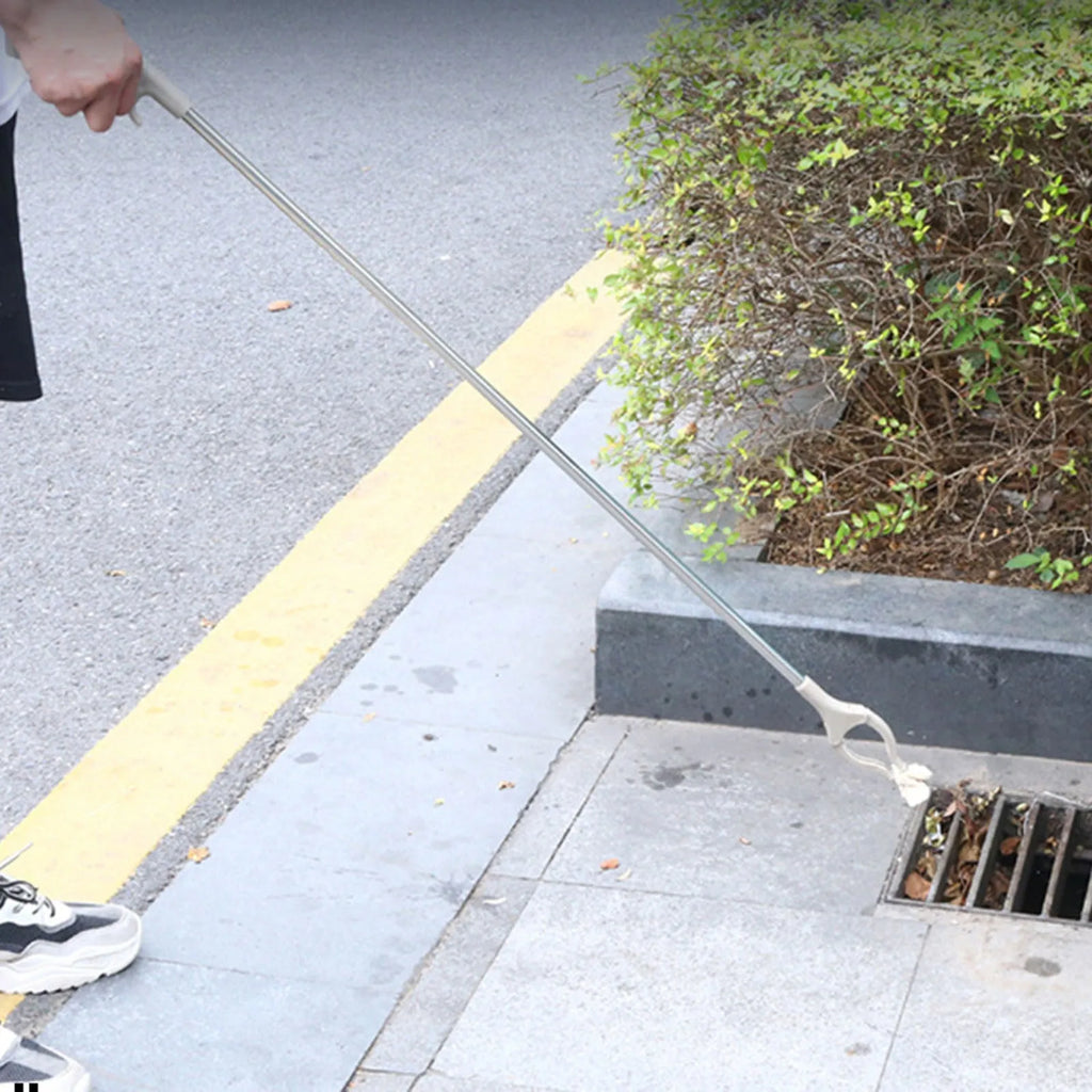 A 40 cm long stainless steel and plastic trash picker tool with a non-slip chuck and push-type handle.
