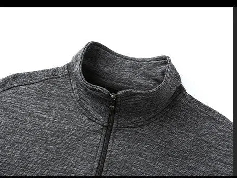 Man wearing a black casual jacket with a stand-up collar and front zip in an athletic fit.