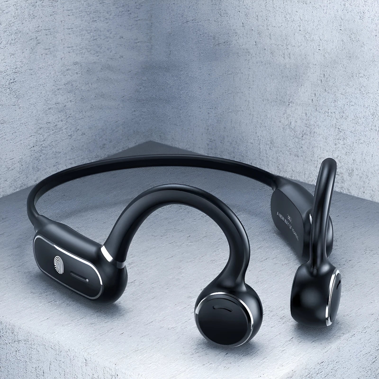 Black air conduction wireless earphone with titanium frame shown bent around a pair of glasses.
