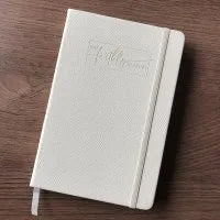 A4 white spiral bound notebook with 200 feint ruled pages open on a desk