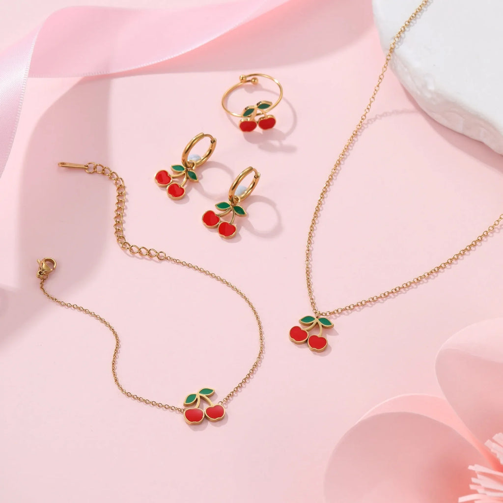 Cherry jewellery set showing necklace, bracelet, earrings, and ring with stainless steel construction