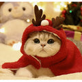 Red polar fleece pet cloak with attached antlers on a small dog, showing the full festive costume.