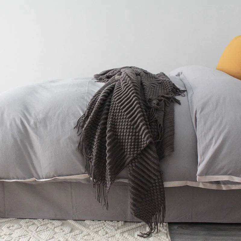 Small light grey polyester nap blanket laid flat showing its 127x170cm size.