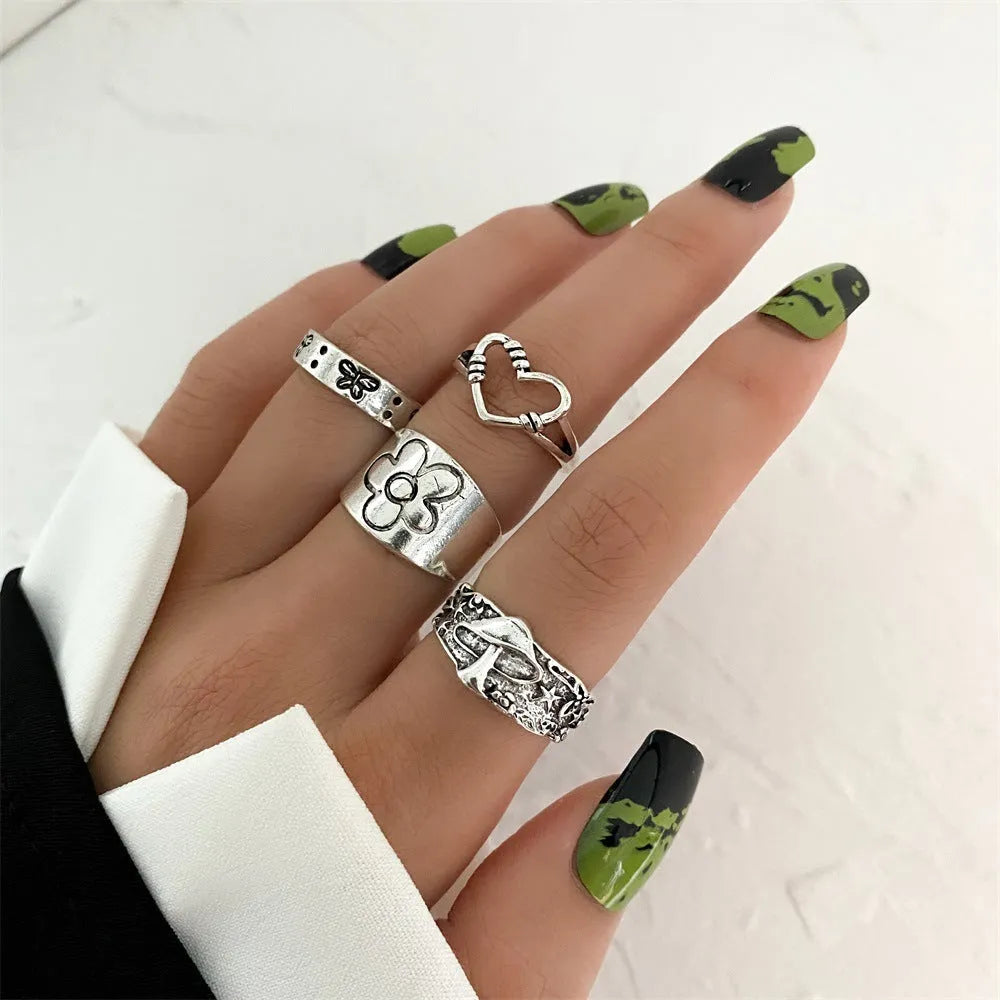 Alloy ring set with butterfly and snake retro geometric designs on display