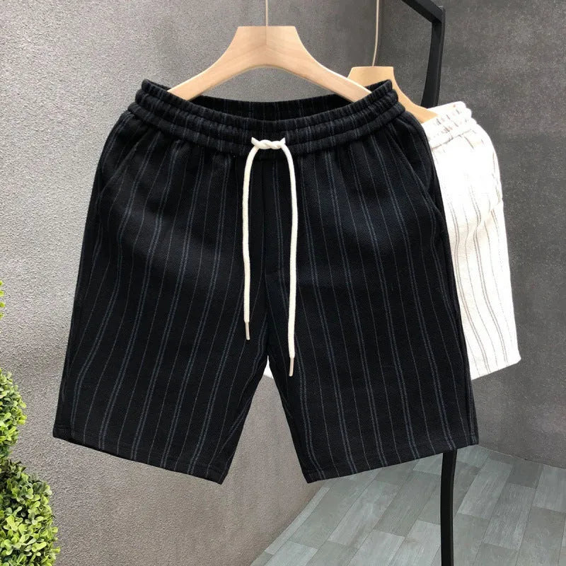 Men's black and white striped casual polyester shorts with an elastic waistband.