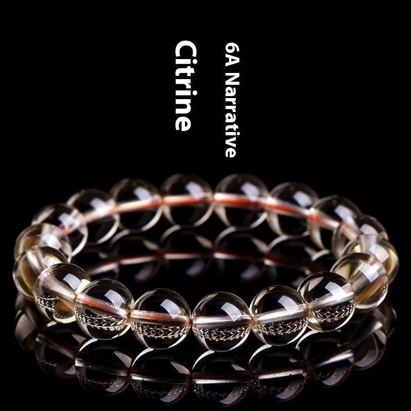 Natural golden citrine bead bracelet with scattered design on a wrist, showing adjustable clasp and polished stone detail.