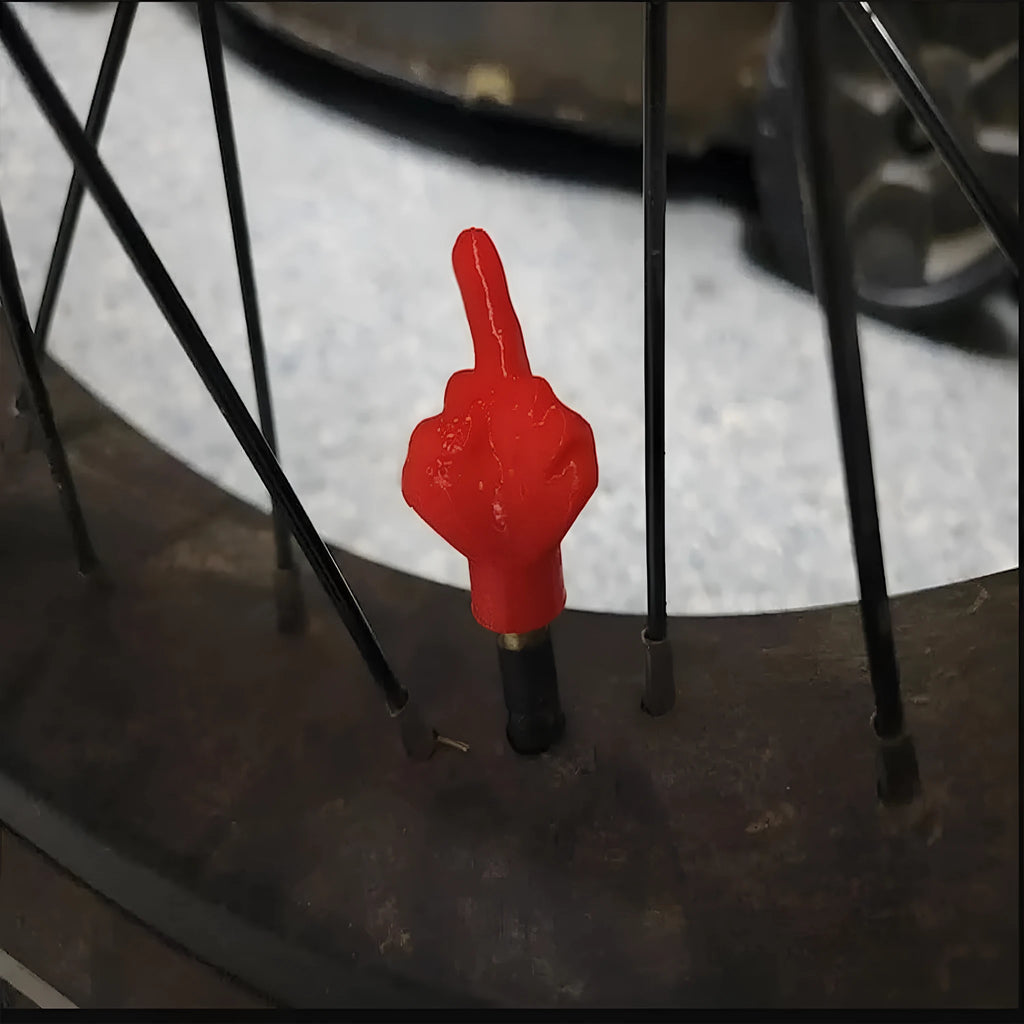 Four latex tyre valve caps - two black and two skin colour pieces for car, bike, and scooter valves