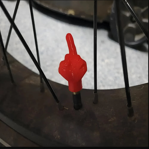 Four latex tyre valve caps showing black and skin colour options for vehicle dust protection