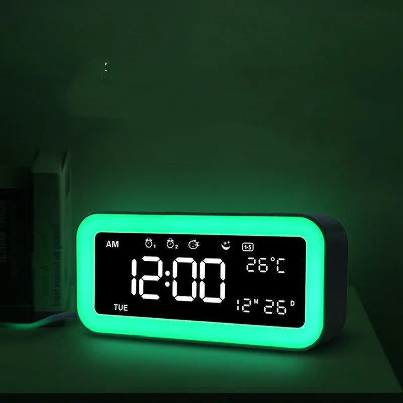 Rectangular blue and pink multifunctional LED atmosphere alarm clock with digital display and quartz glass mirror.