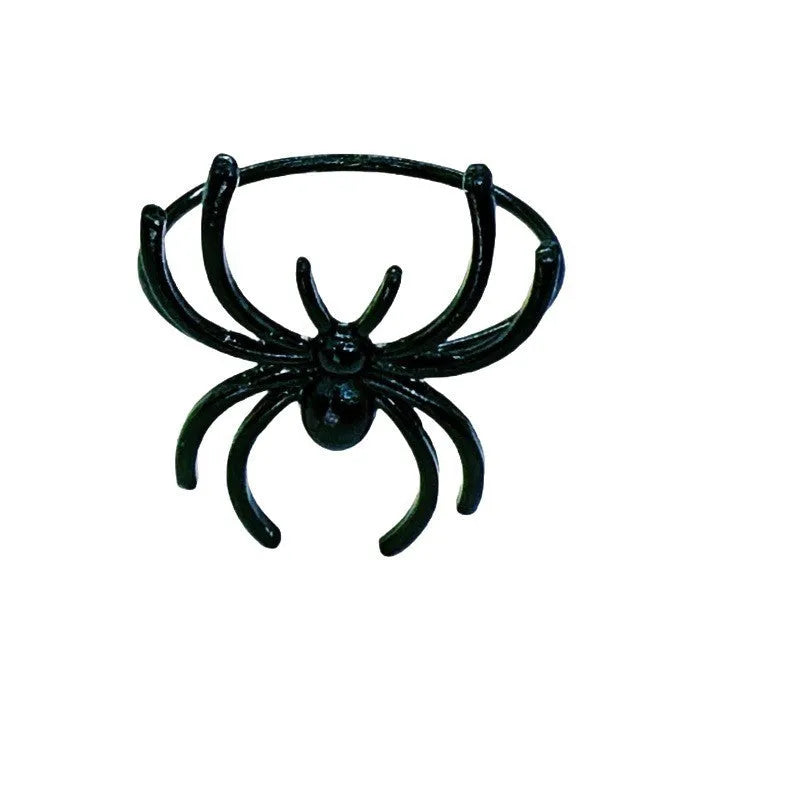 Set of six black alloy spider-shaped napkin rings for Halloween table decoration.