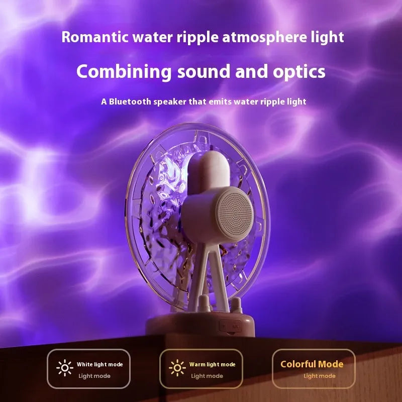 Pink and white Bluetooth speaker projecting colourful Ferris wheel and water ripple LED light patterns