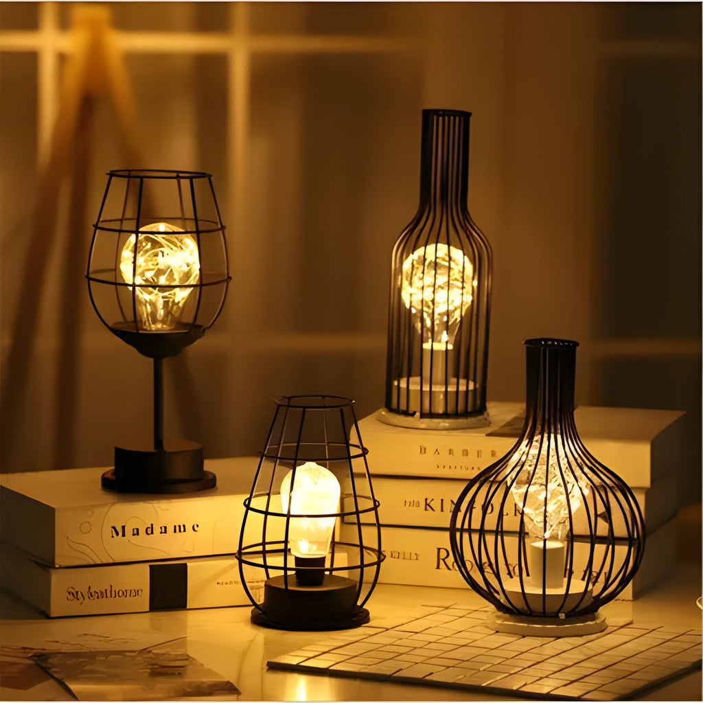 Minimalist hollow wrought iron table lamp in red wine bottle design with warm white LED light.