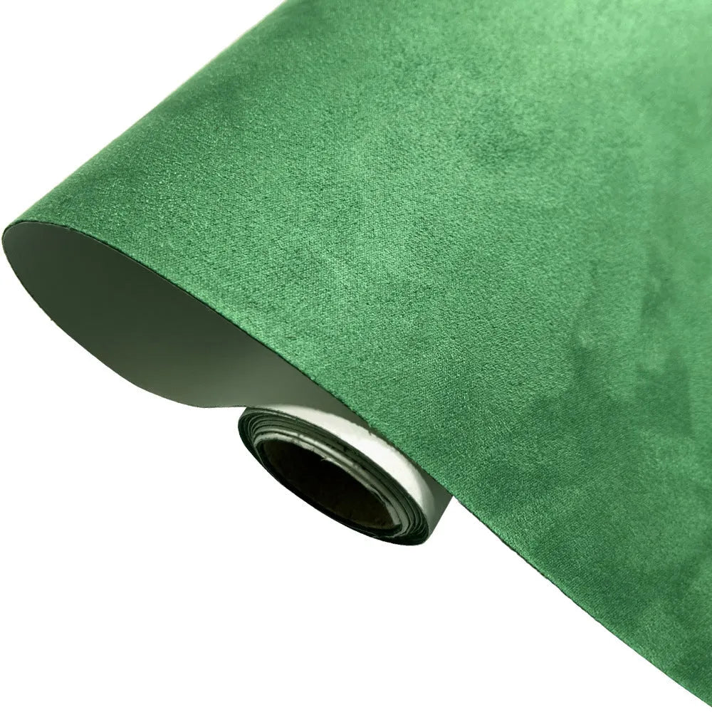 Roll of self-adhesive leather suede fabric in BMW brown colour next to a car dashboard.