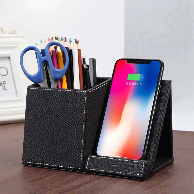 Black leather desk organiser with pen slots and a wireless phone charging pad on top