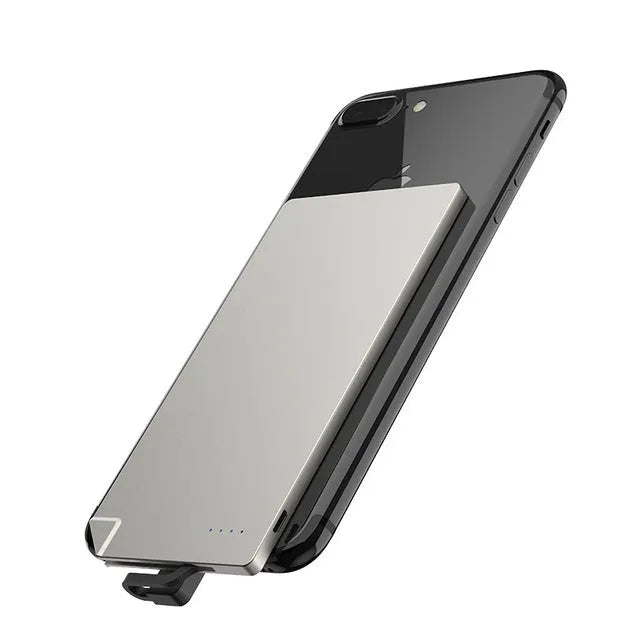 Silver ultra-thin 4mm graphene power bank next to a mobile phone showing its slim profile.