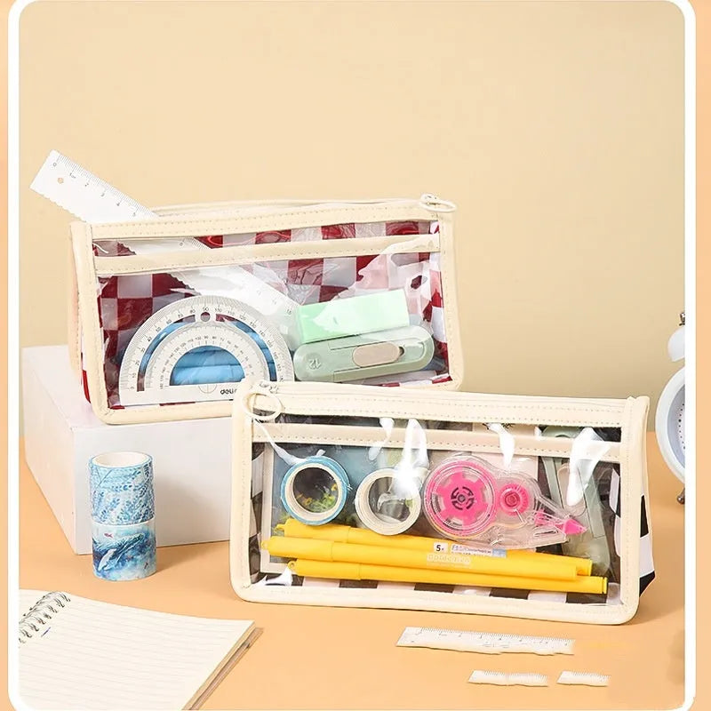 Transparent PVC pencil case with a chessboard pattern, showing pens inside.