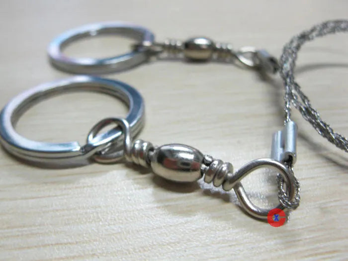 Stainless steel survival wire saw with ring attachments showing 55cm cutting length