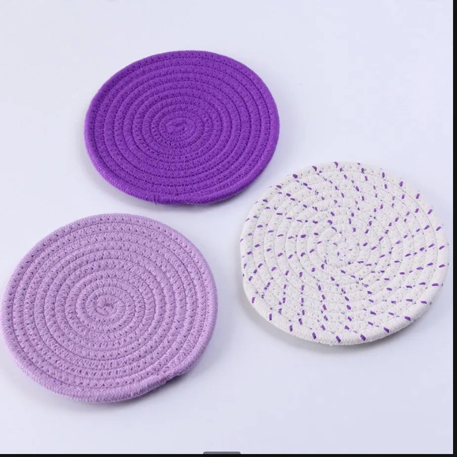 Three round cotton cord coasters in 18cm diameter showing grey, pink, purple and blue colour options