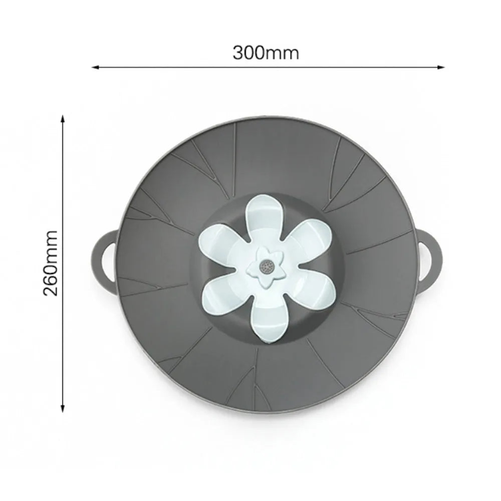 Silicone spill-proof pot cover in black, size 30x26cm, resting on a pot